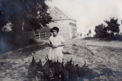 Dziewczynka karmiąca indyki, w tle widoczny spichlerz przy dworze, 1932 r.
